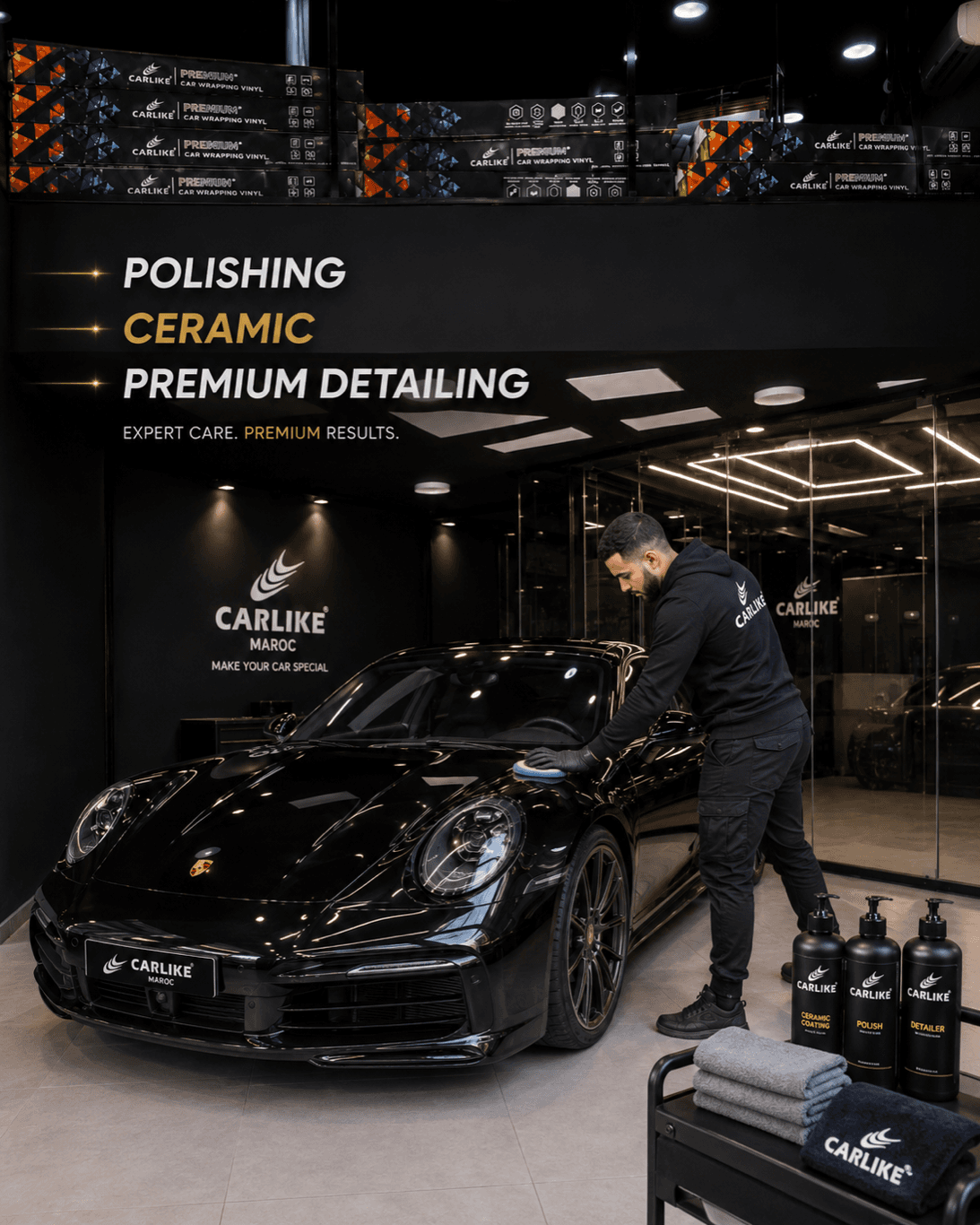Detailer working on a black Porsche 911 in the Carlike polishing and ceramic studio in Casablanca — PPF vs ceramic coating
